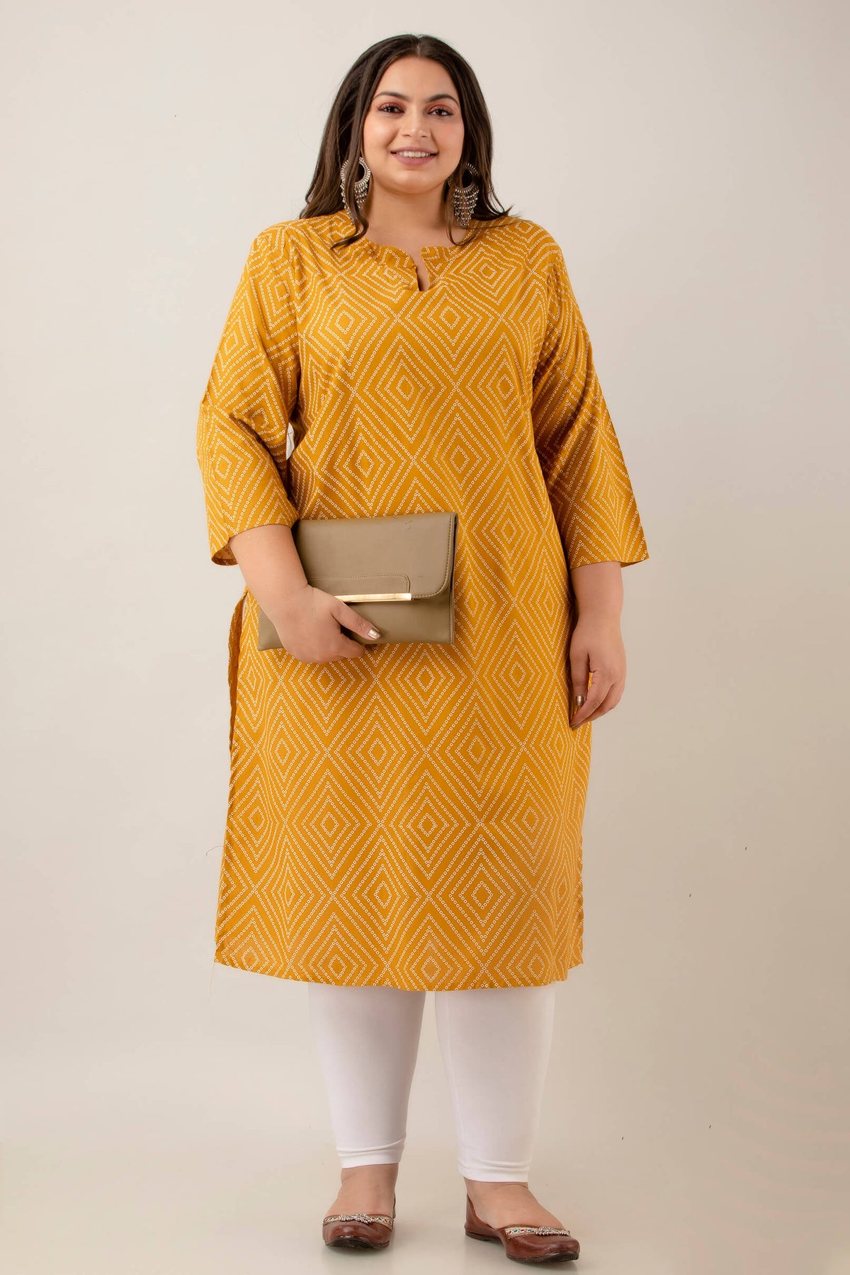 Styled look with white leggings and juttis; mustard rayon kurti with geometric diamonds; confidence-boosting, fat-friendly outfit.