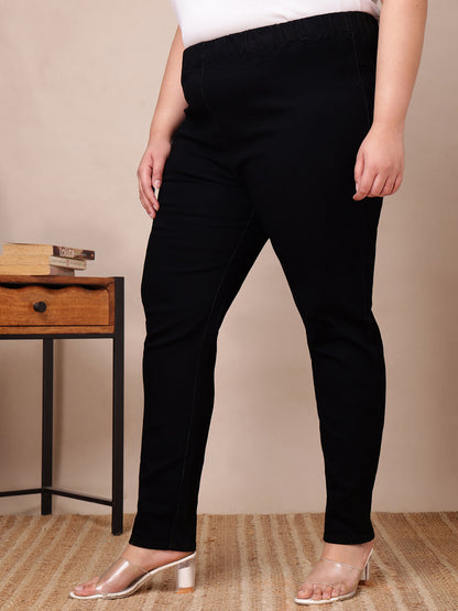 Side angle of black denim jeggings for curvy and fat women showing tapered slim design – Curvisha
