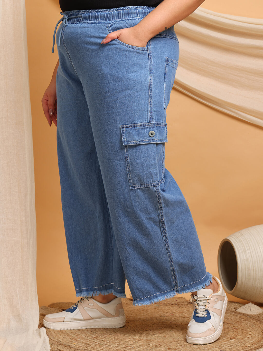 Side pocket close-up of blue denim cargo pants for curvy women – Curvisha