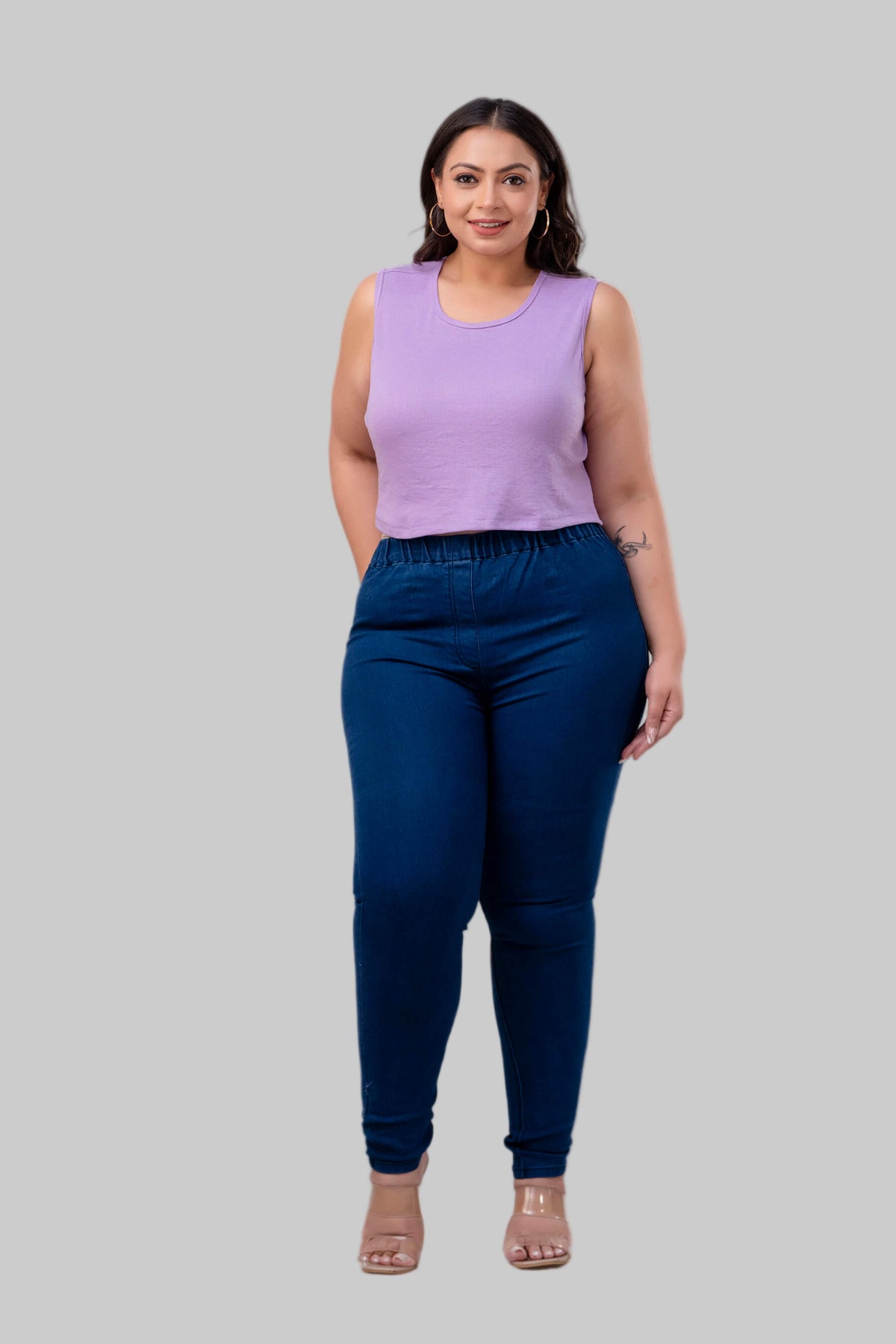 Full front view of plus size blue denim jeggings for curvy women styled with lilac tank top – Curvisha