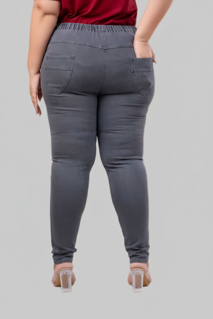 Back view of plus size grey stretch jeggings with curved patch pockets and elastic waist – Curvisha