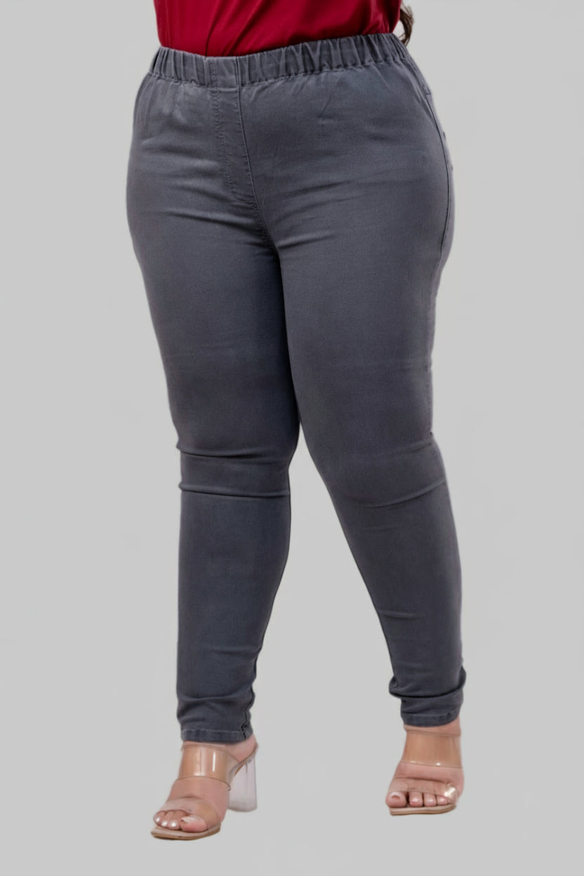 Three-quarter angle of grey denim jeggings highlighting soft stretch fabric and slim silhouette – Curvisha