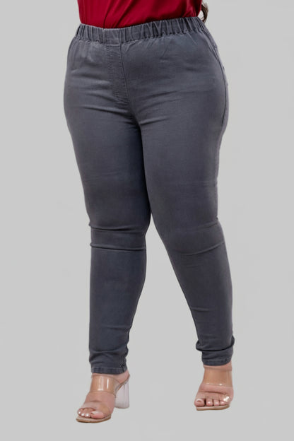 Three-quarter angle of grey denim jeggings highlighting soft stretch fabric and slim silhouette – Curvisha