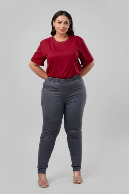 Walking pose of model in plus size grey denim jeggings styled with red tee – Curvisha