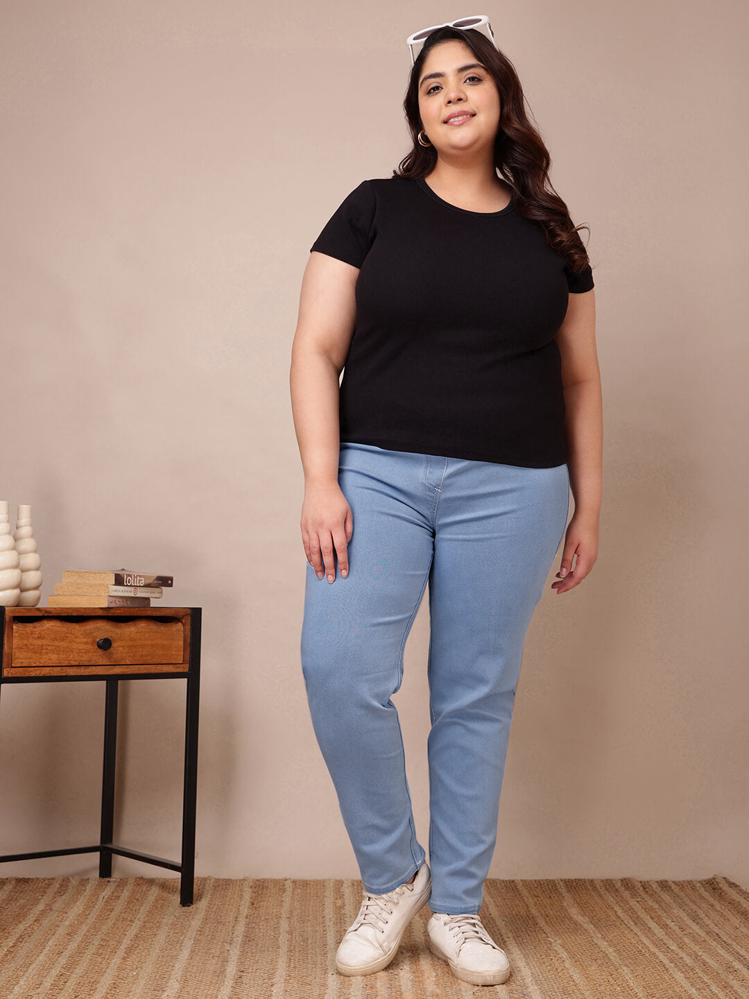 Full front view of plus size light blue denim jeggings styled with black top for curvy women – Curvisha