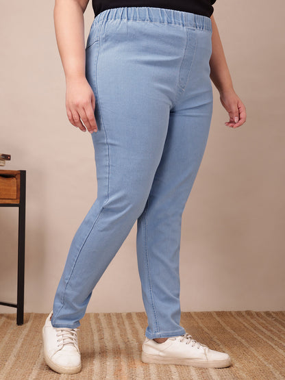 Side view of plus size light blue denim jeggings showing stretch fabric and ankle length – Curvisha