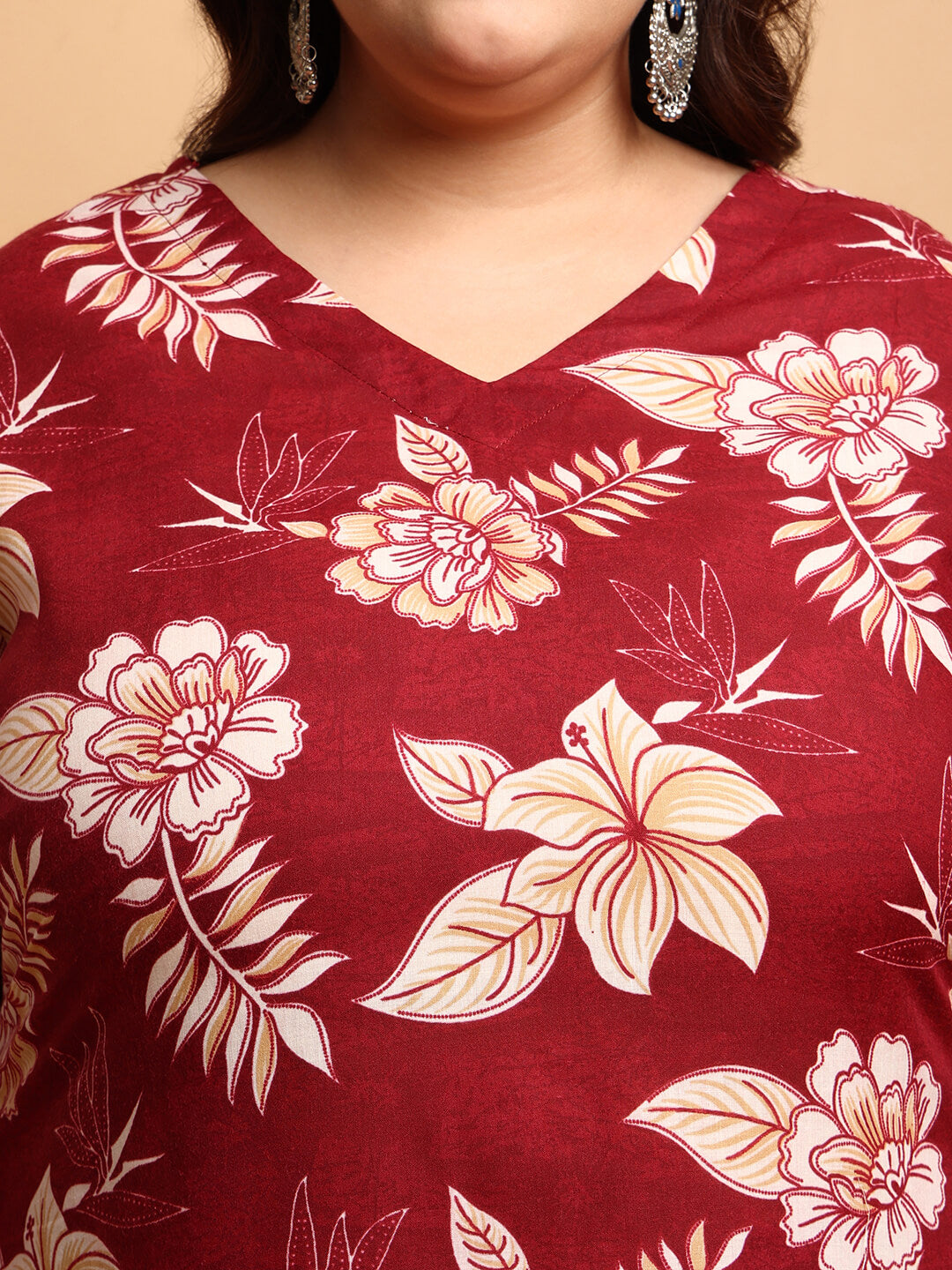 Close-up of V-neck maroon cotton kurti with beige floral print and detailed stitching for full figure women – Curvisha