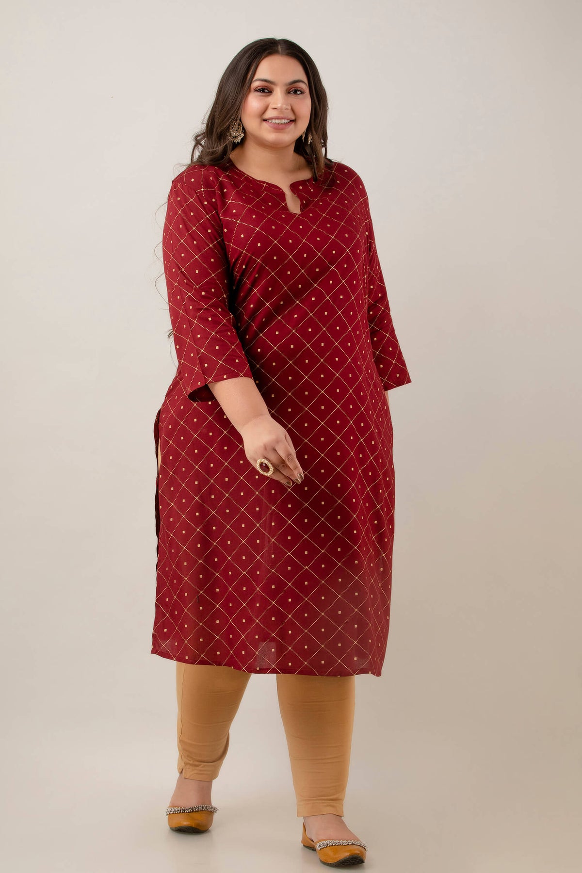 Front view maroon rayon kurti with notch neck and 3/4 sleeves; elegant geometric print; smart workwear option for curvy shoppers.