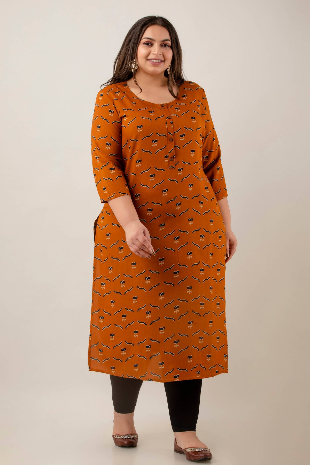 Walking shot of Plus Size abstract print rayon kurti on mustard base, office to casual look, fat-friendly drape, sizes 3XL–9XL