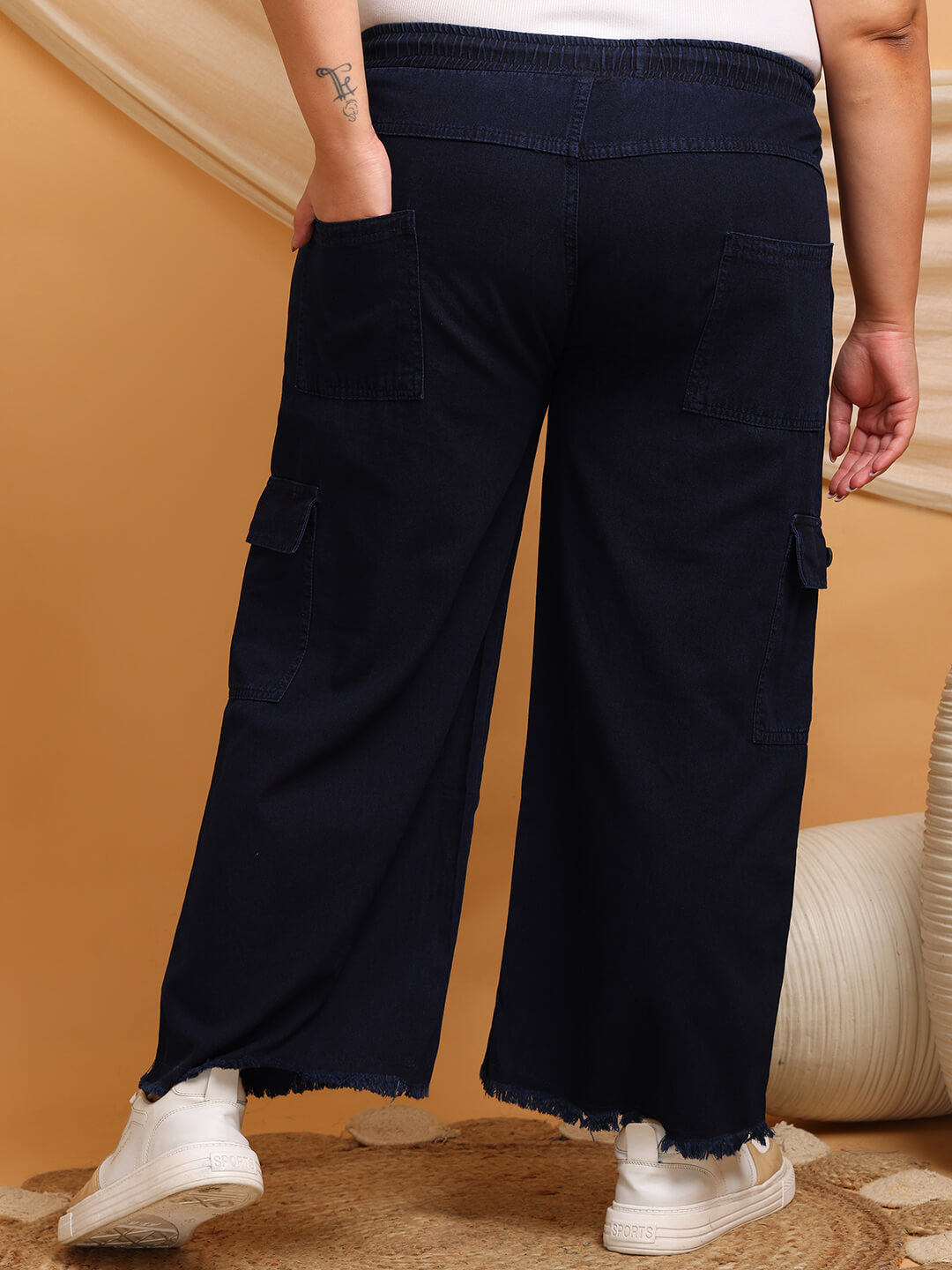 Back view of navy blue denim cargo pants with elastic waistband and patch pockets – Curvisha