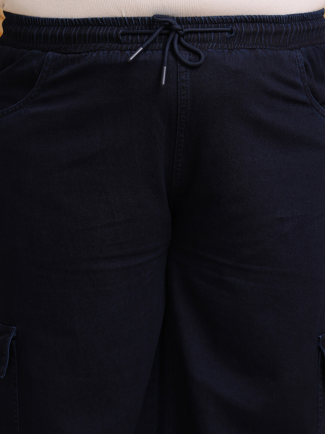 Close-up of navy blue denim cargo pants showing drawstring waist and pocket detail – Curvisha
