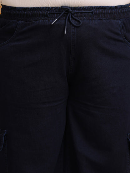 Close-up of navy blue denim cargo pants showing drawstring waist and pocket detail – Curvisha