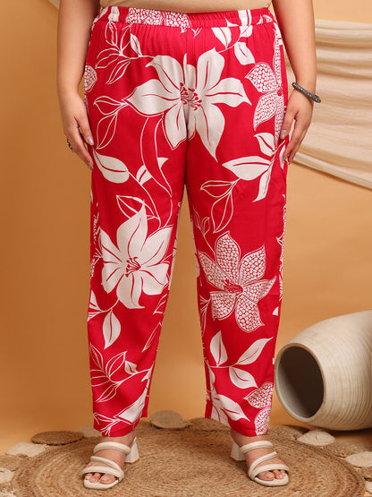 Plus size red rayon floral printed pants close-up with elastic waist and pockets, comfortable fit for curvy women – Curvisha