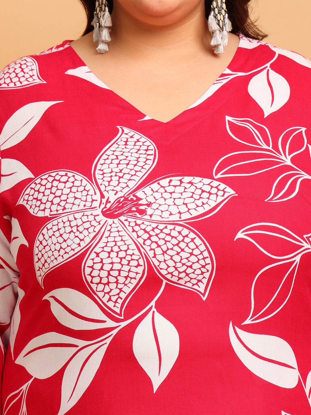 Close-up of V-neck red rayon kurti with bold white floral design and smooth drape for curvy women – Curvisha