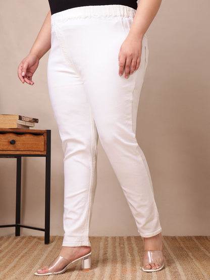 Side angle of plus size white denim jeggings highlighting slim tapered fit and soft stretch – Curvisha