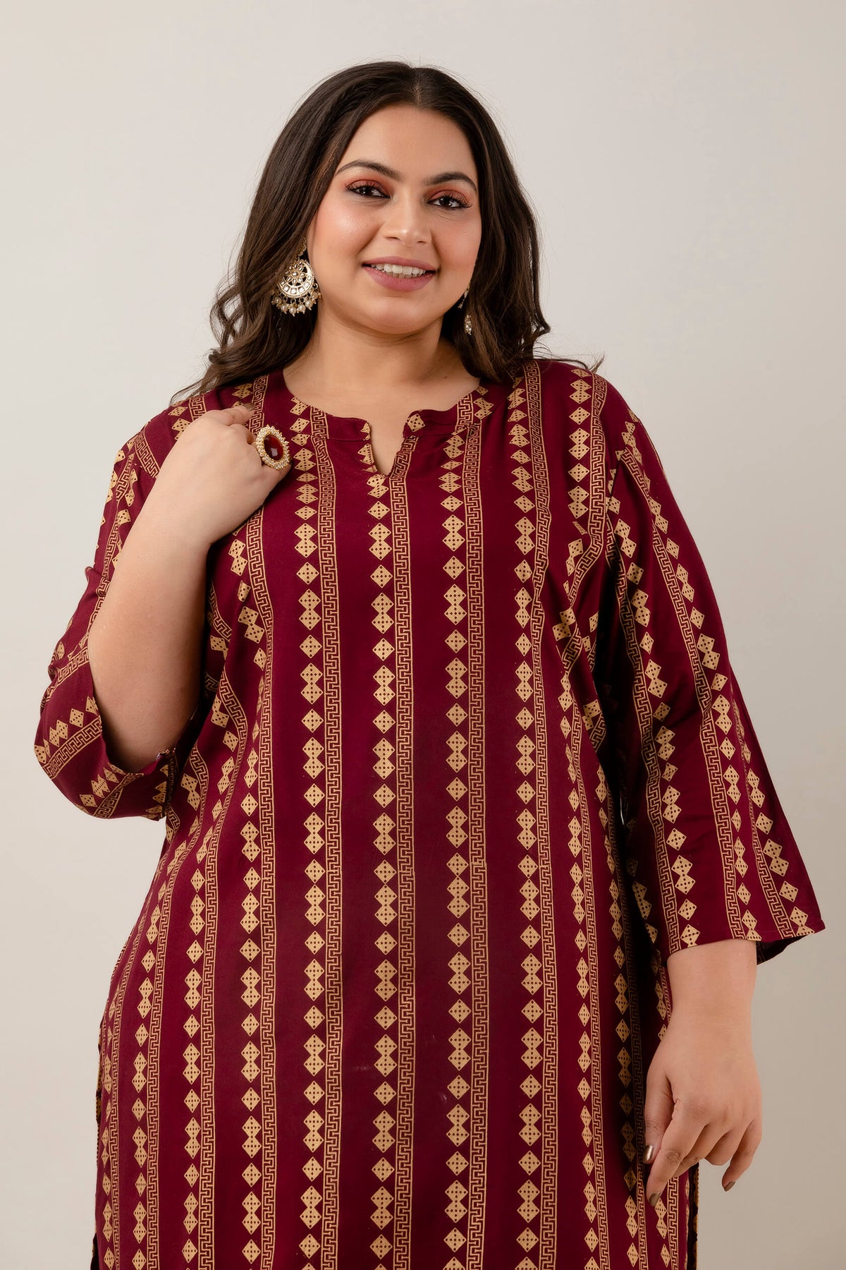 Fabric detail showing gold geometric vertical print on maroon rayon kurti for plus size outfits