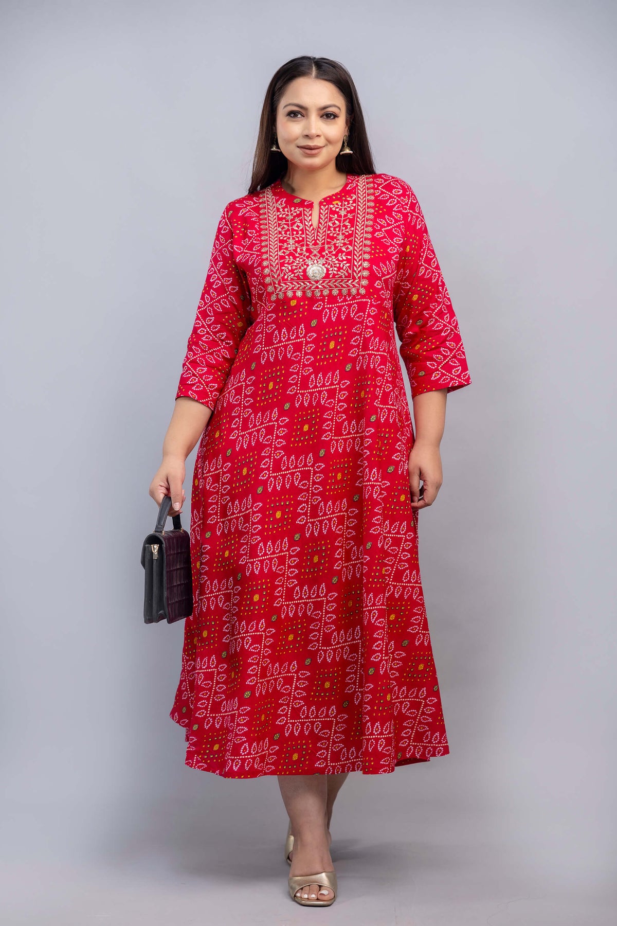 Front full length pose of plus size red bandhani embroidered gown