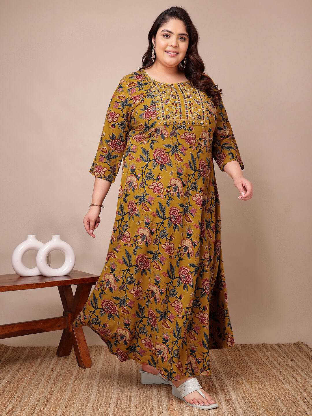Walking pose showing mustard floral rayon gown for curvy women