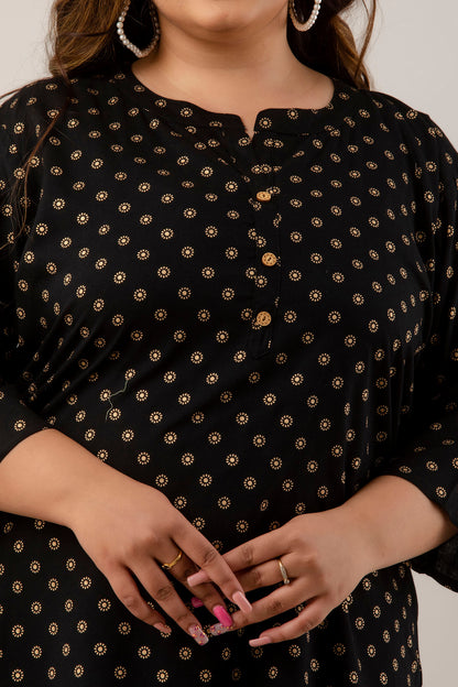 close up of plus size woman wearing a black polka dot tunic