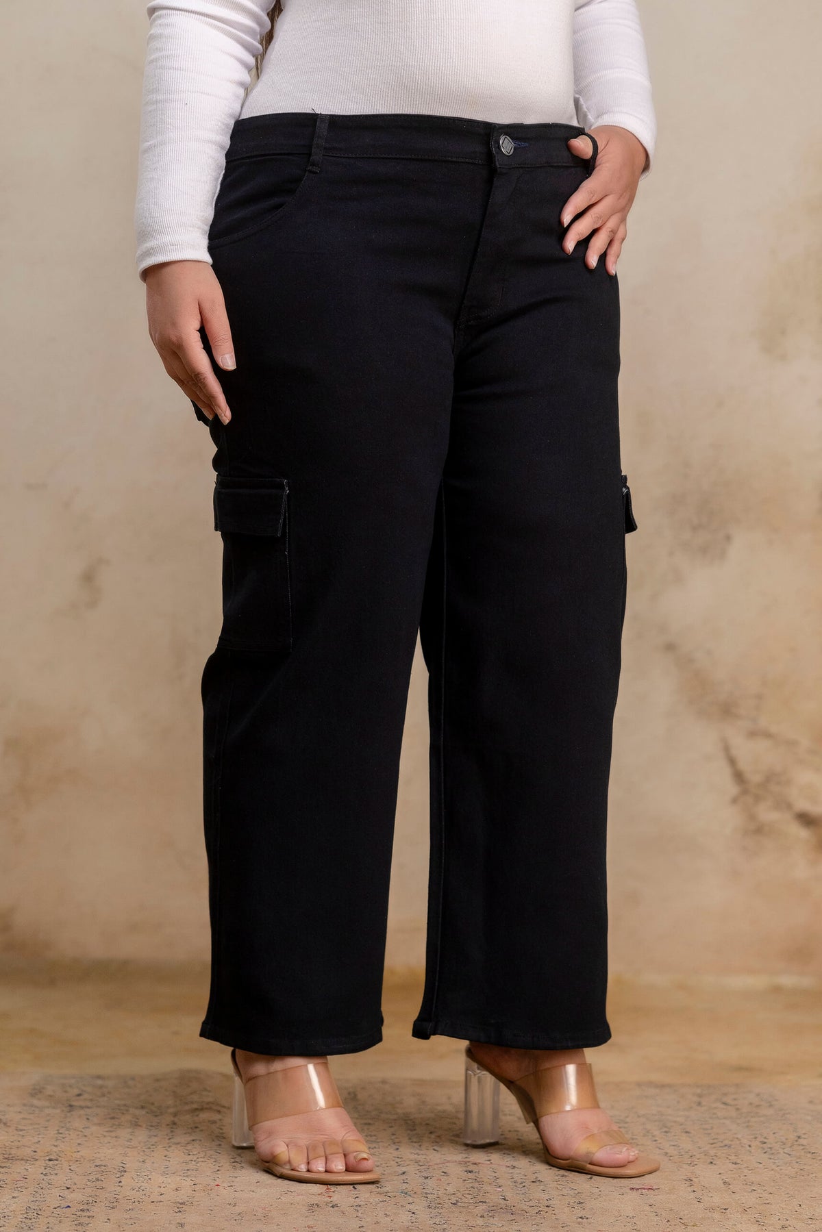 Plus size buttoned black denim pants angled view for women, wide leg big size clothing