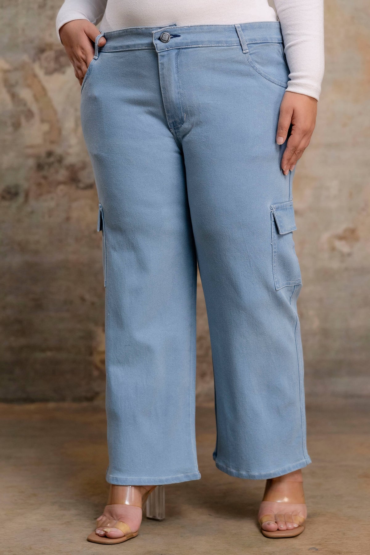 Plus size buttoned light blue denim pants waist detail for women, stretch big size clothing close up