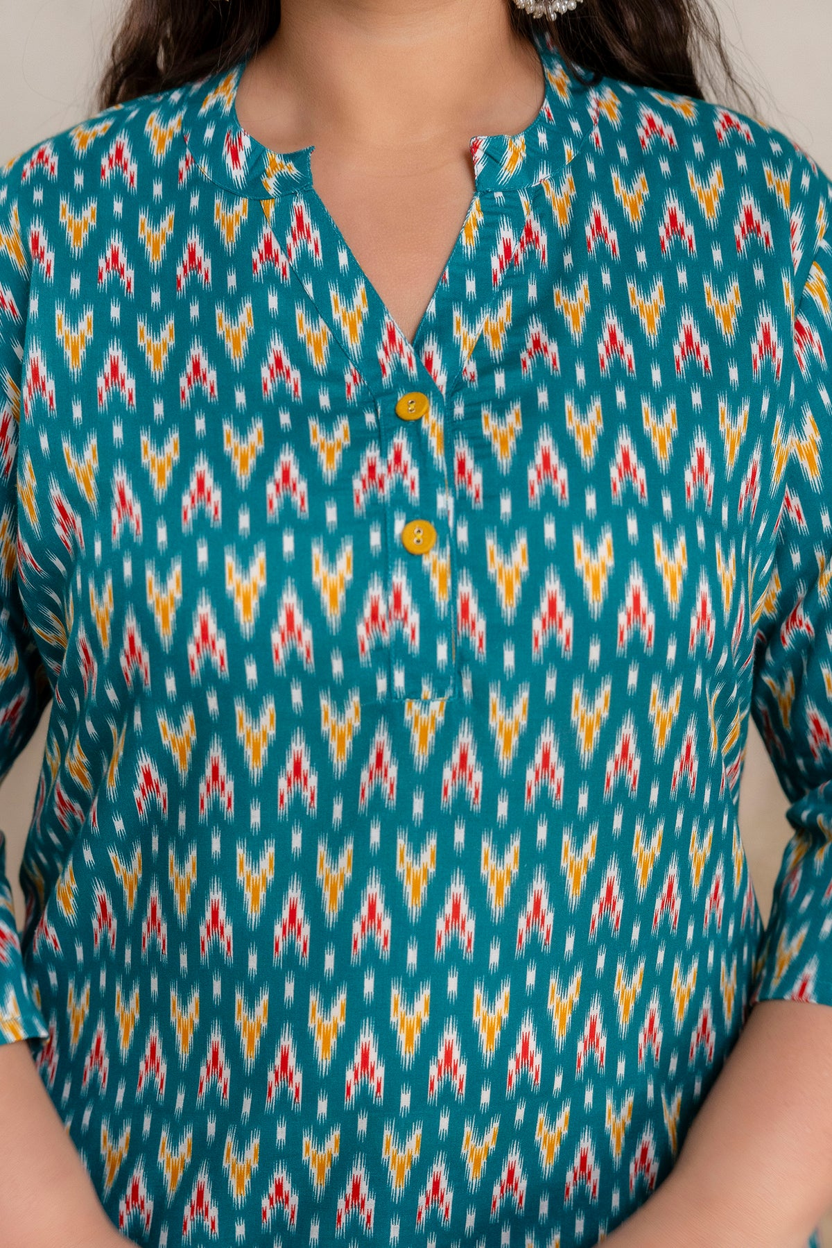 Close up neckline detail of plus size teal green ikat cotton short kurti