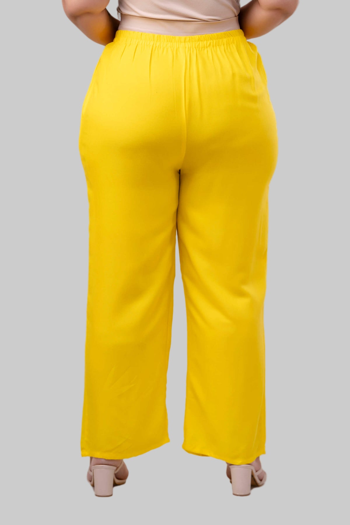 Back view of yellow rayon palazzo pants for curvy women, wide-leg and flattering silhouette – Curvisha