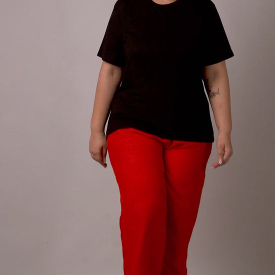 Eye-catching bright red fashion palazzos with a breezy silhouette, styled with a black tee.