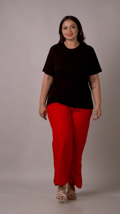 Eye-catching bright red fashion palazzos with a breezy silhouette, styled with a black tee.