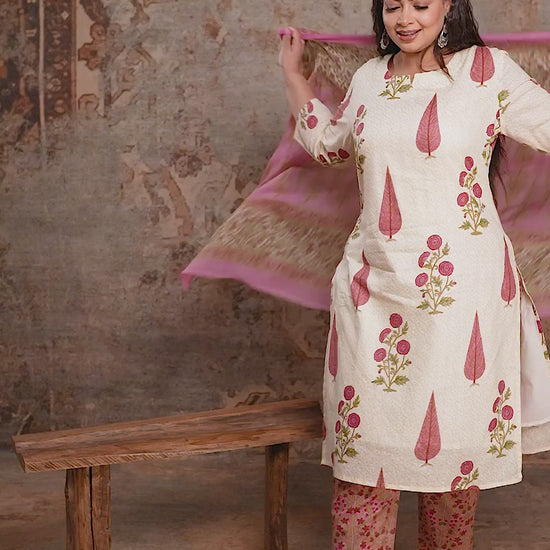 Cream plus size ethnic suit with large pink floral motifs and printed dupatta, showing the relaxed fit and flowy fabric from Curvisha.