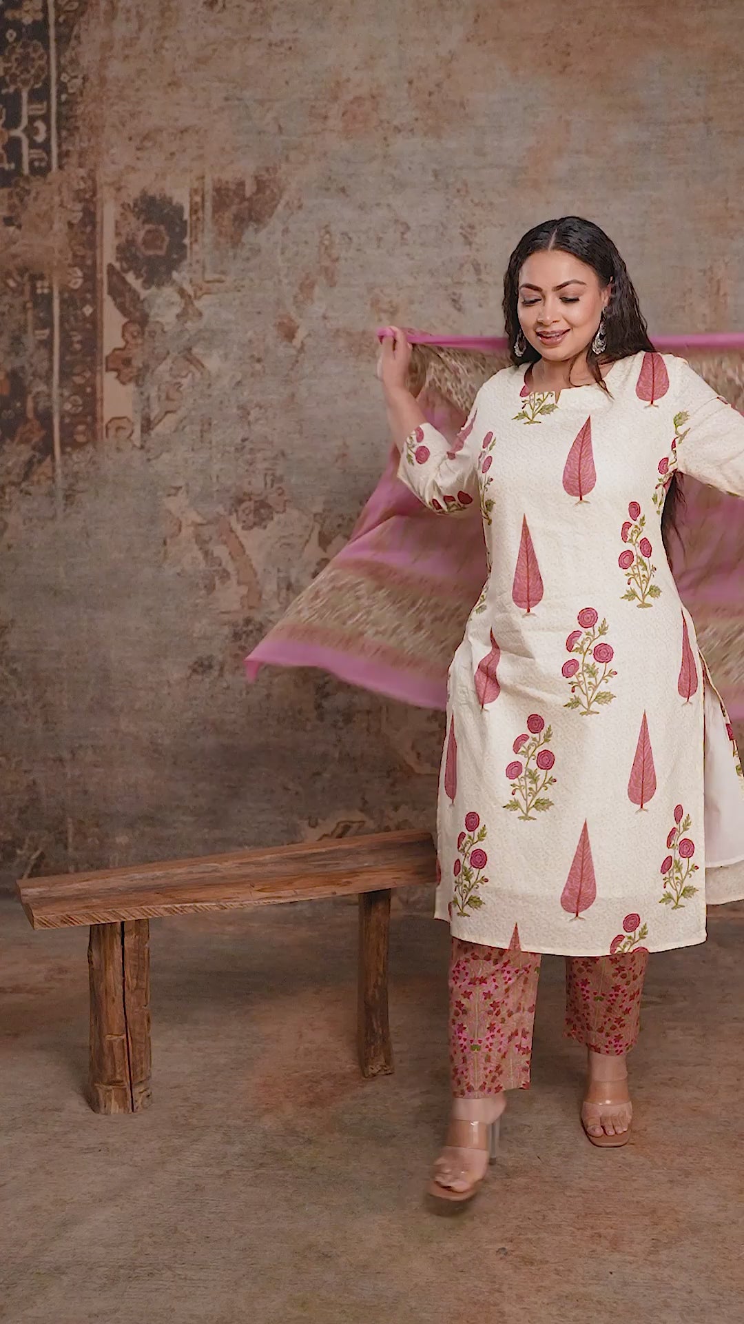 Cream plus size ethnic suit with large pink floral motifs and printed dupatta, showing the relaxed fit and flowy fabric from Curvisha.