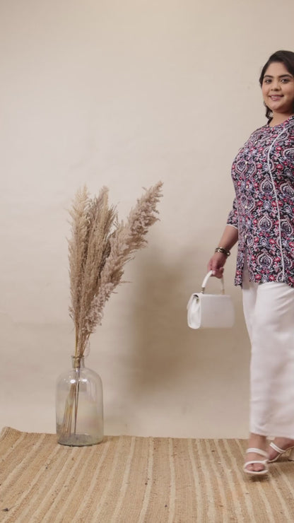 Crisp white cotton palazzo pants with a relaxed fit, styled with a floral tunic and white handbag.