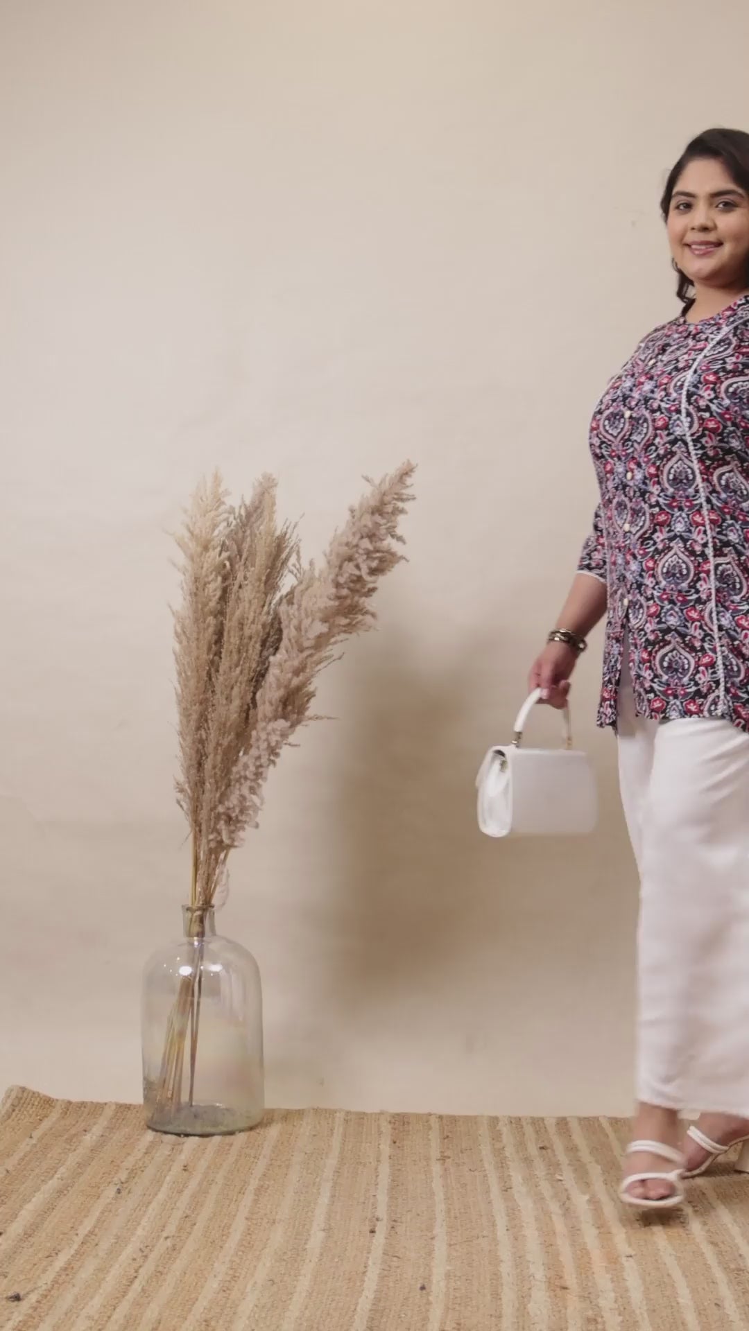 Crisp white cotton palazzo pants with a relaxed fit, styled with a floral tunic and white handbag.