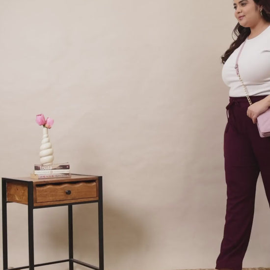 Plus-size model showcasing Curvisha wine-colored ribbed lounge pants, highlighting the soft texture and flexible drawstring waist.