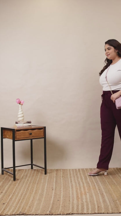 Plus-size model showcasing Curvisha wine-colored ribbed lounge pants, highlighting the soft texture and flexible drawstring waist.