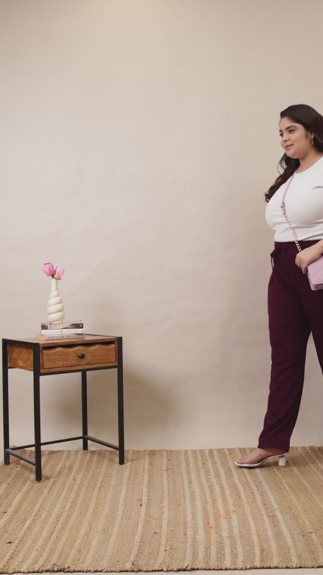 Plus-size model showcasing Curvisha wine-colored ribbed lounge pants, highlighting the soft texture and flexible drawstring waist.