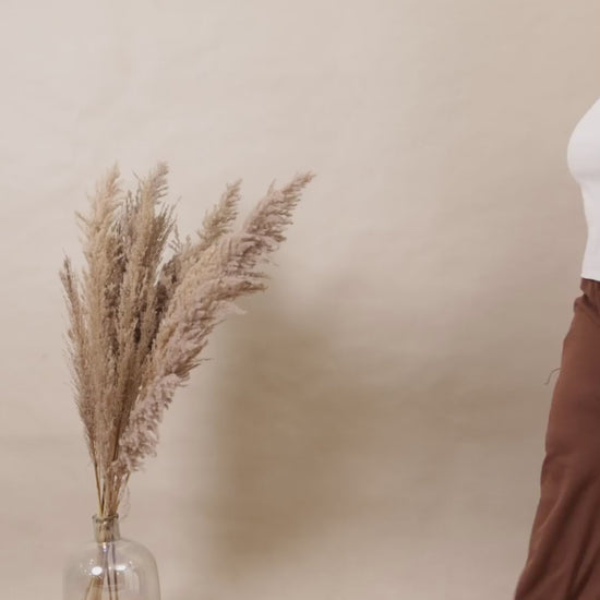 Close-up of Curvisha brown ribbed lounge pants for plus-size figures, showing the durable fabric quality and flattering wide-leg silhouette.