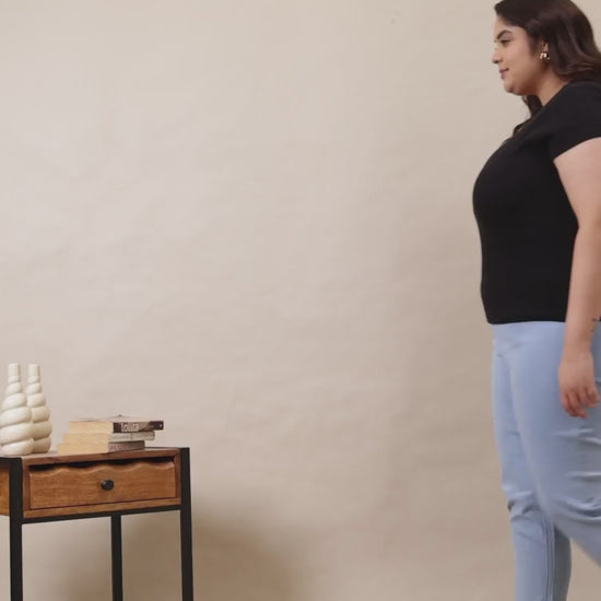 A woman wearing Curvisha high-waisted denim jeggings in a light wash, showing the stretch and fit from multiple angles.