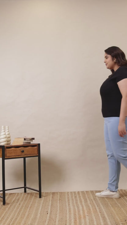 A woman wearing Curvisha high-waisted denim jeggings in a light wash, showing the stretch and fit from multiple angles.