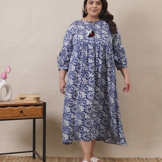 Elegant blue and white floral print maxi dress with a relaxed fit and tassel details, perfect for plus-size fashion.