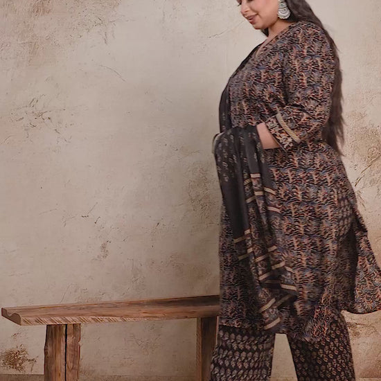Black plus size floral print suit set with sheer dupatta, showcasing the premium fabric movement and elegant curvy silhouette.