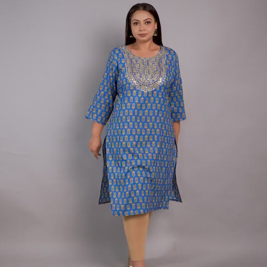 Curvisha plus-size blue ethnic kurta featuring gold leaf patterns and a heavily sequined embroidered neckline, styled with beige leggings.