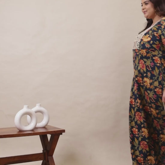 Curvisha navy blue plus size maxi kurta with vibrant floral prints and delicate white lace embroidery on the bodice for a graceful look.
