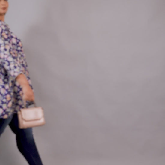 Stylish plus size blue floral tiered tunic top from Curvisha, paired with denim for a modern look.