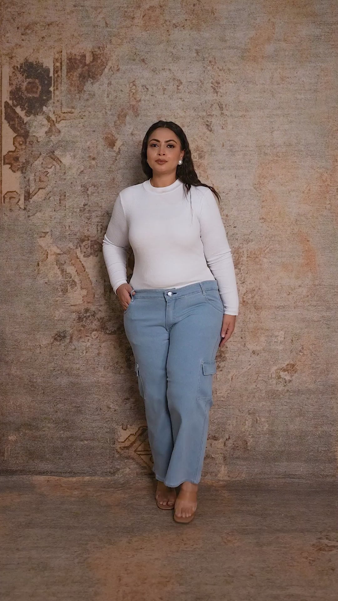 Plus size woman showcasing Curvisha utility buttoned denim pants with functional side pockets and premium stitching.