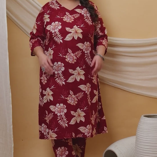 A burgundy plus-size co-ord set featuring a delicate white hibiscus print, long tunic with side slits, and comfortable straight-fit pants.