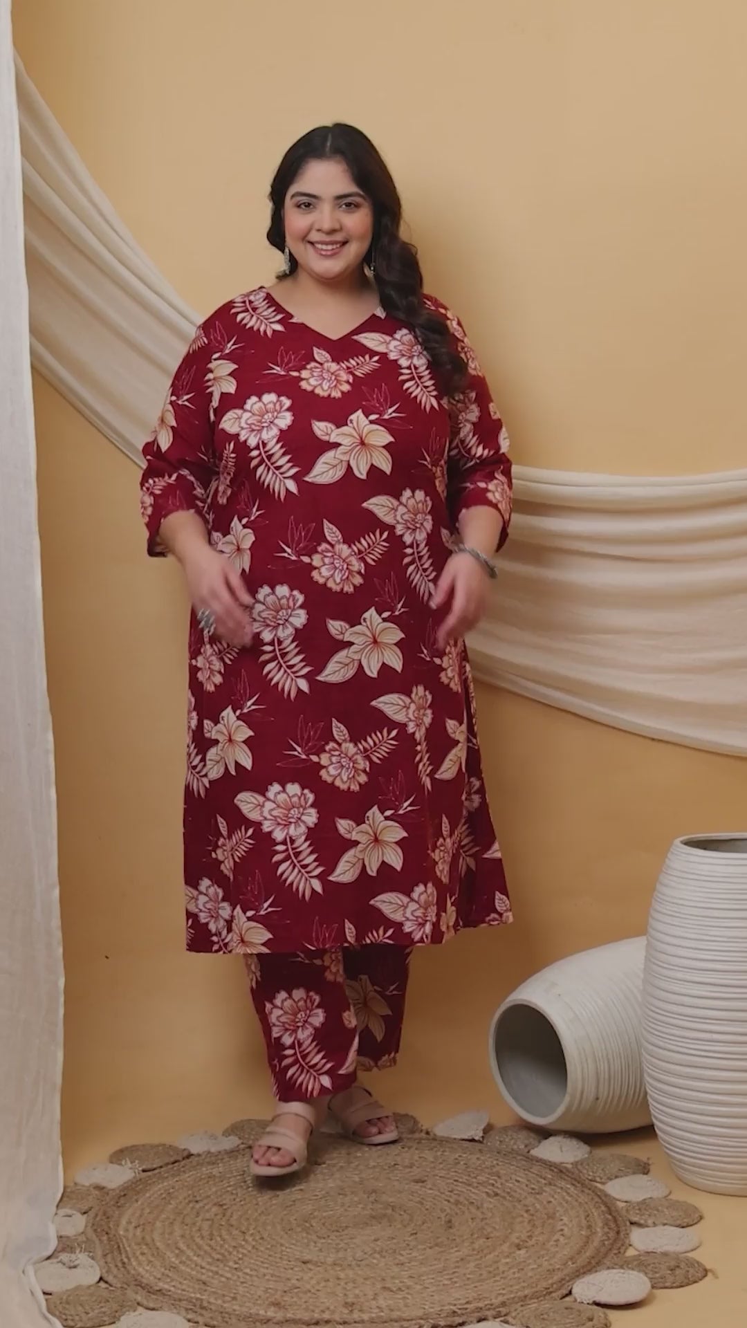 A burgundy plus-size co-ord set featuring a delicate white hibiscus print, long tunic with side slits, and comfortable straight-fit pants.