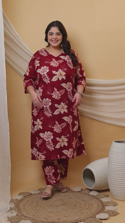 A burgundy plus-size co-ord set featuring a delicate white hibiscus print, long tunic with side slits, and comfortable straight-fit pants.