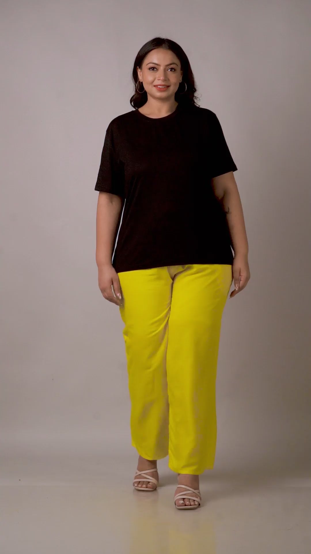 Bold and vibrant yellow palazzo pants with a high-waisted elastic band, perfect for a bright summer look.