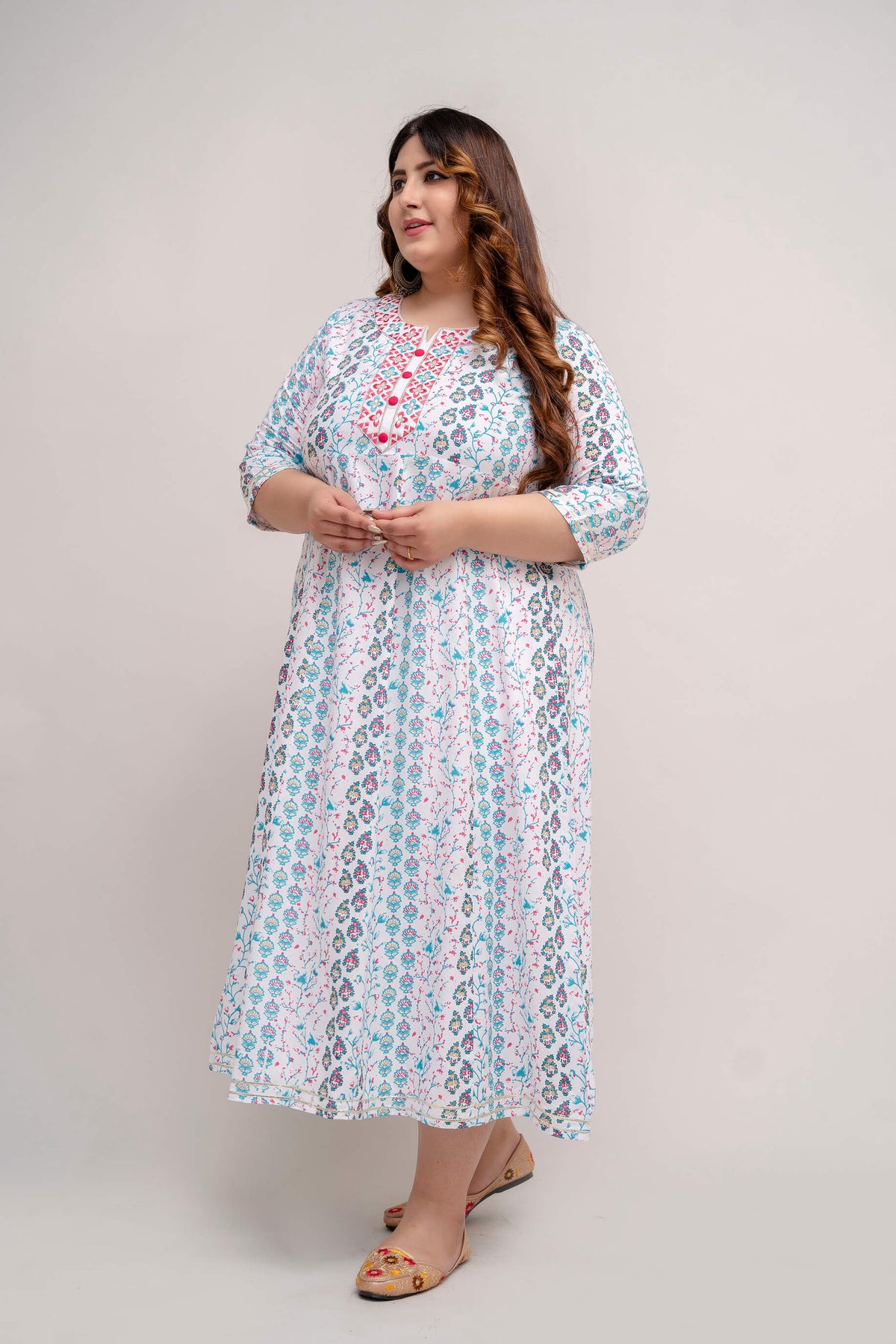 Side pose of plus size white turquoise rayon gown with soft flare